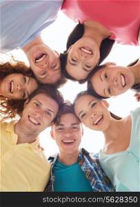 friendship, youth and people - group of smiling teenagers in circle