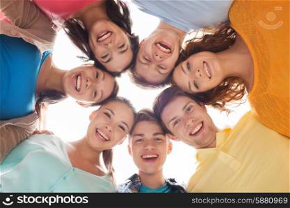 friendship, youth and people - group of smiling teenagers in circle