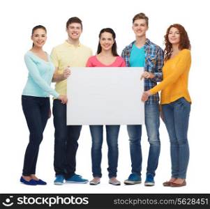 friendship, youth and people - group of smiling teenagers with big white blank billboard