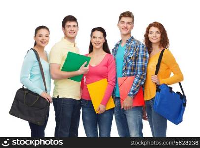 friendship, youth, education and people concept - group of smiling teenagers with folders and school bags