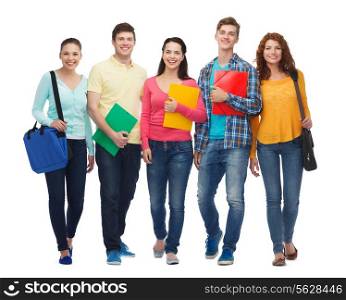friendship, youth, education and people - group of smiling teenagers with folders and bags