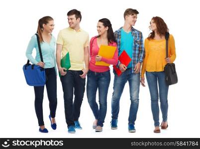 friendship, youth, education and people - group of smiling teenagers with folders and bags