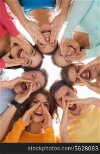 friendship, youth, gesture and people - group of smiling teenagers in circle shouting