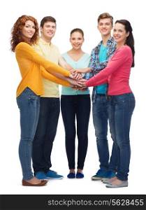 friendship, youth, gesture and people - group of smiling teenagers with hands on top of each other