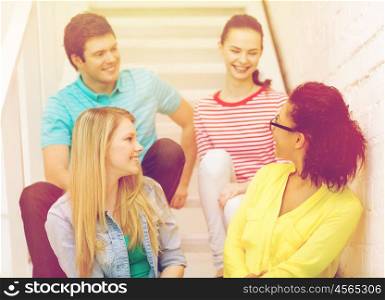 frienship and education concept - smiling teenagers hanging out. smiling teenagers hanging out