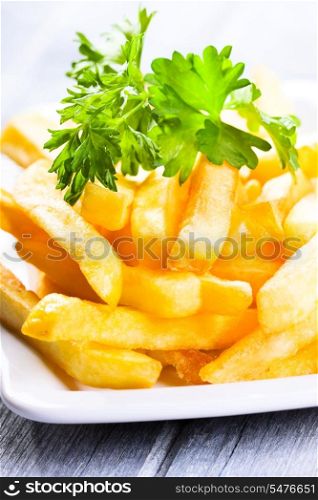 fries potatoes on wooden table