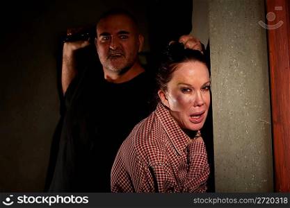 Frightened woman in hallway with menacing man