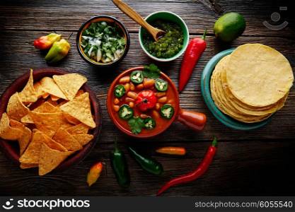 Frijoles charros mexican beans with chili pepper sides and tortillas