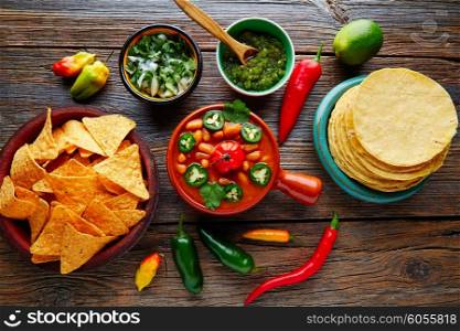 Frijoles charros mexican beans with chili pepper sides and tortillas