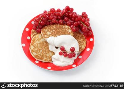 Fritters with sour cream and a red currant
