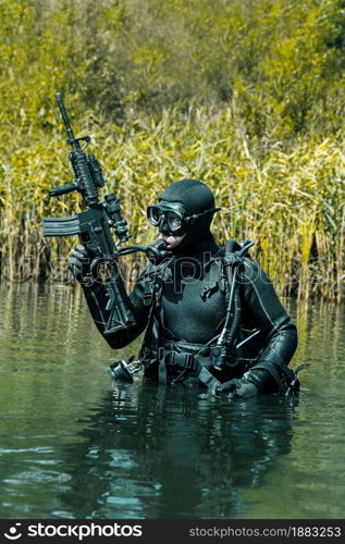 Frogman with complete diving gear and weapons in the water. Frogman with weapons