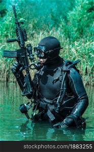Frogman with complete diving gear and weapons in the water. Frogman with weapons