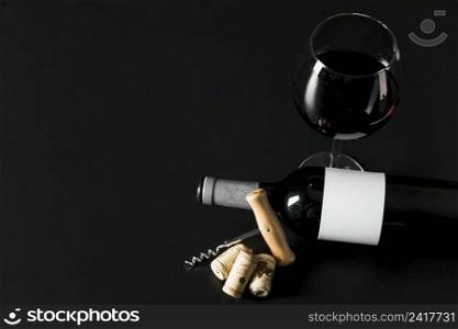 from corkscrew near bottle wineglass