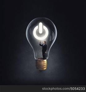 From inside of idea. Man holding luminous idea inside light bulb