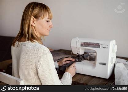 from shot woman using sewing machine