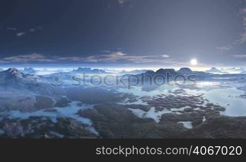 From the misty horizon a bright white sun rises and flies through the great sky among the floating white clouds. Below the mountain valley and many lakes. The sky reflects in the water.