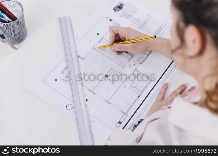 from woman drawing blueprint