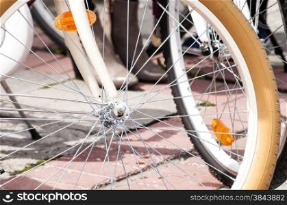 Front bicycle wheels with metal spokes closeup