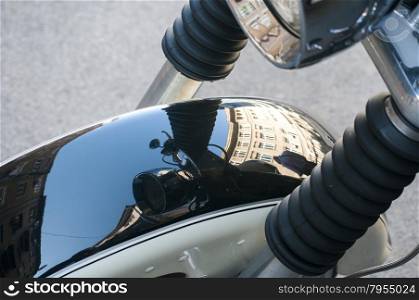 Front fender of classic vintage motorcycle closeup with mirror reflection