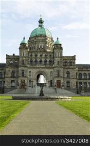 Front of capital building in Victoria Canada with water fountain along with blue sky and clouds in background