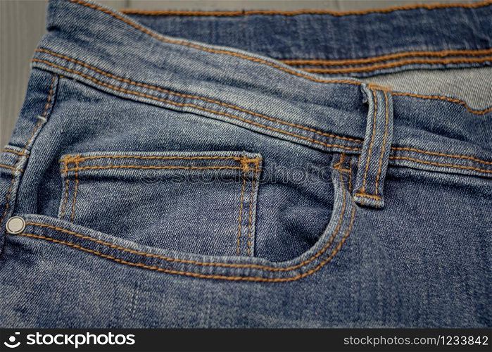 Front pockets of a washed blue denim pants