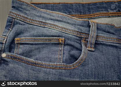 Front pockets of a washed blue denim pants