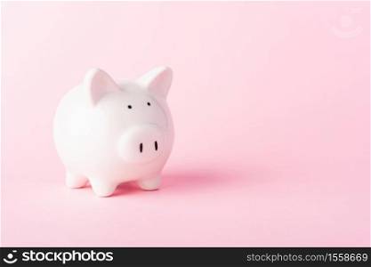 Front small white fat piggy bank, studio shot isolated on pink background and copy space for use, Finance, deposit saving money concept