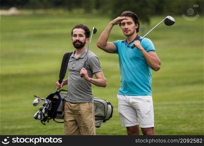 front view adult friends playing golf