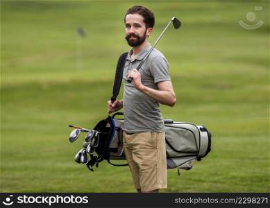 front view adult man with golf clubs