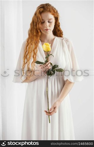 front view alluring woman posing with spring flower