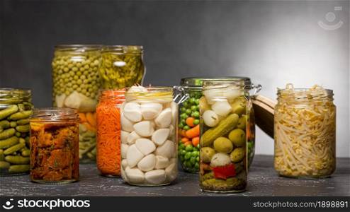 front view assortment vegetables pickled clear glass jars. Resolution and high quality beautiful photo. front view assortment vegetables pickled clear glass jars. High quality beautiful photo concept