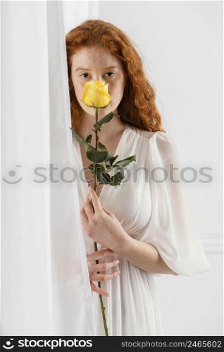 front view beautiful woman posing with spring flower