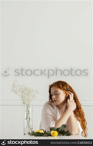 front view beautiful woman posing with spring flowers copy space