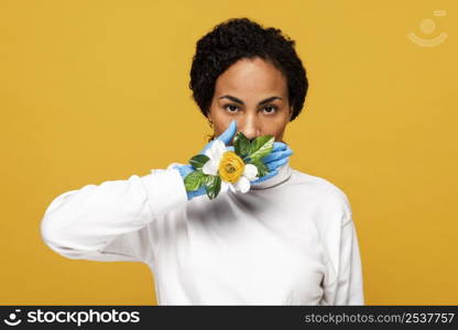 front view beautiful woman with floral gloves covering her mouth