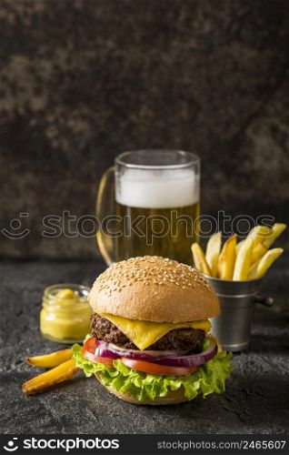 front view beef burger fries sauce with beer copy space