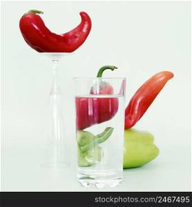 front view bell chili peppers with glass water