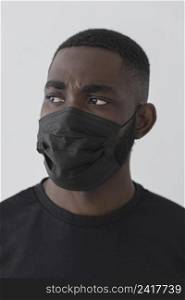 front view black person wearing mask looking away