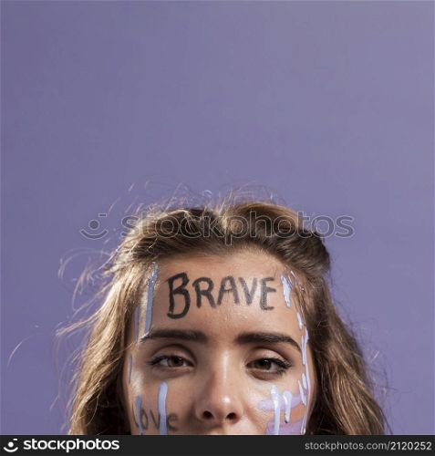 front view blonde woman covered with empowering words paint