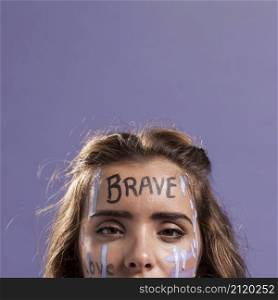 front view blonde woman covered with empowering words paint