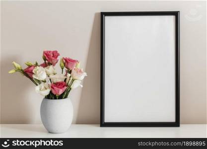 front view bouquet roses vase with empty frame. Resolution and high quality beautiful photo. front view bouquet roses vase with empty frame. High quality beautiful photo concept