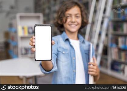 front view boy holding empty screen phone library