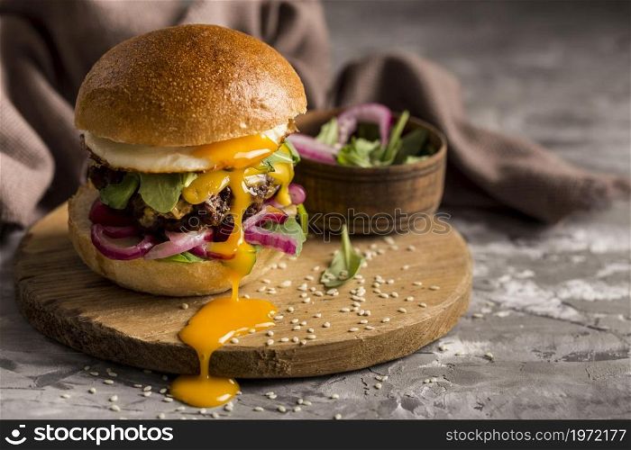 front view burger with fried egg cutting board. High resolution photo. front view burger with fried egg cutting board. High quality photo