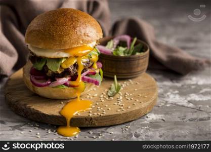 front view burger with fried egg cutting board. High resolution photo. front view burger with fried egg cutting board. High quality photo