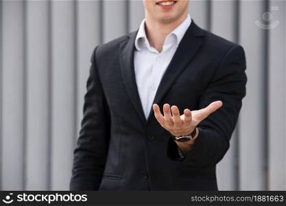 front view businessman holding hand out
