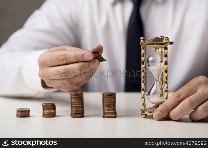 front view businessman with coins hourglass