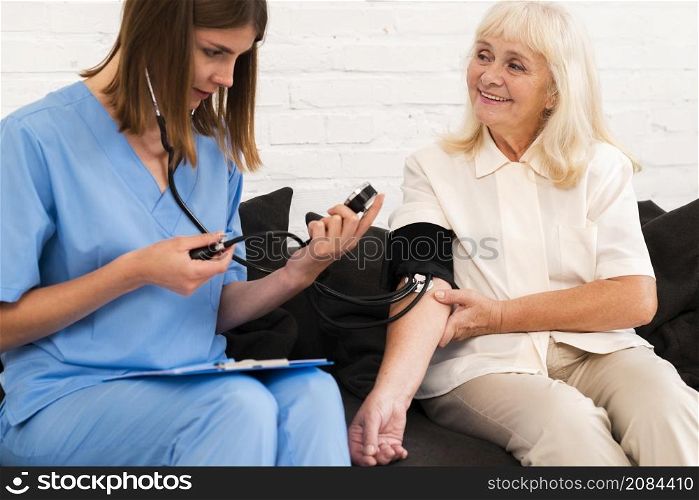 front view checking old woman s blood pressure