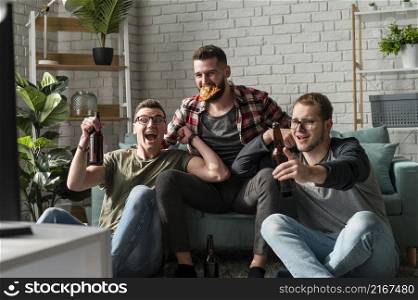 front view cheerful male friends having pizza beer watching sports tv