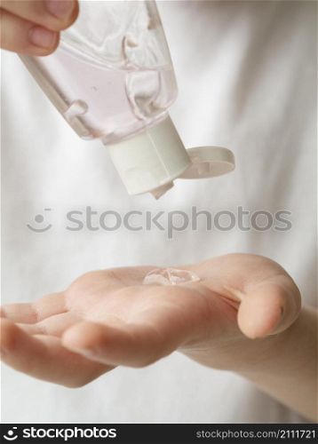 front view child using hand sanitizer