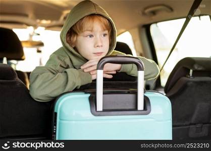 front view child with luggage inside car