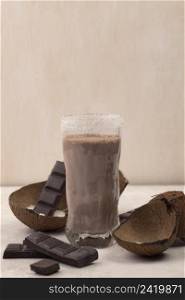 front view chocolate milkshake glass with coconut copy space